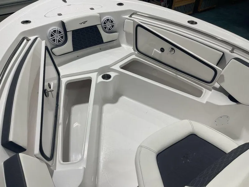 Slide: The Image of 2025 Tidewater 210 LXF boat interior with storage compartments and speakers. - 11