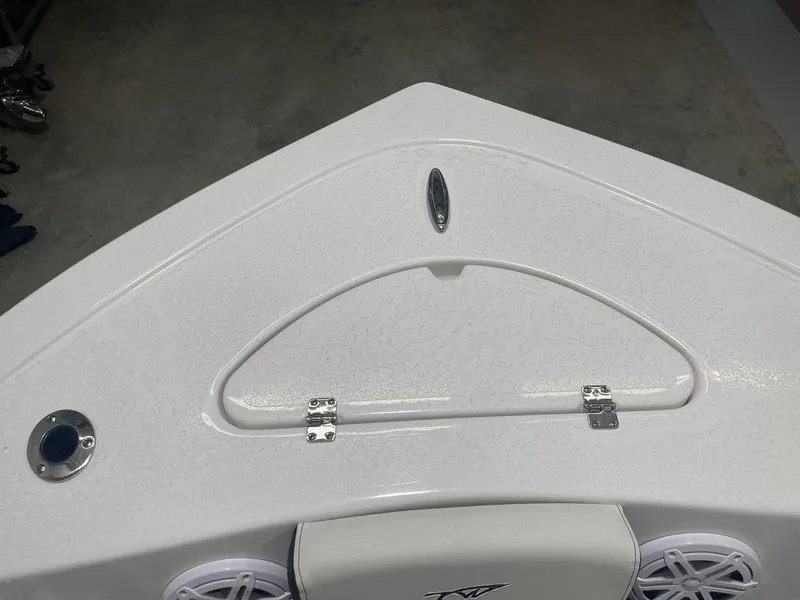 Slide: The Image of 2025 Tidewater 210 LXF boat bow with storage compartment and speakers. - 13