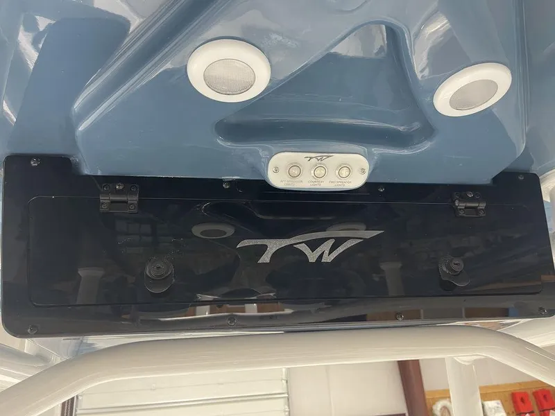 Slide: The Image of 2025 Tidewater 210 LXF boat interior ceiling with logo and lighting fixtures. - 18