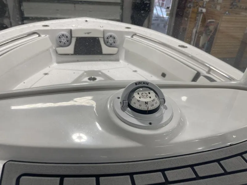 Slide: The Image of 2025 Tidewater 210 LXF boat interior with compass and speakers. - 19