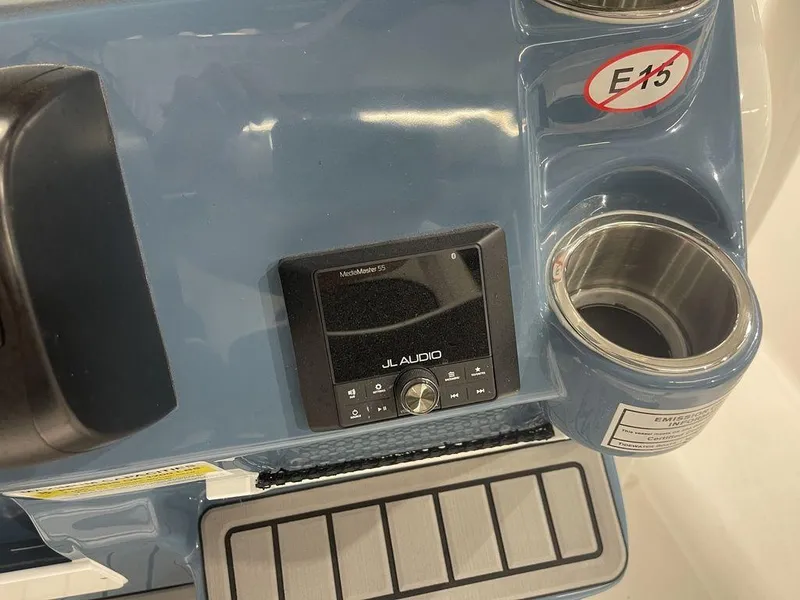 Slide: The Image of JL Audio system on 2025 Tidewater 210 LXF boat dashboard with cup holder. - 22