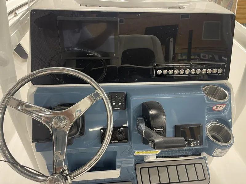 Slide: The Image of Dashboard of 2025 Tidewater 210 LXF boat with steering wheel and controls. - 26