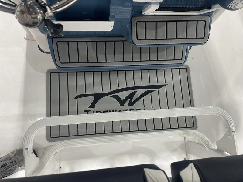 Slide: The Image of 2025 Tidewater 210 LXF boat interior with branded flooring and seating. - 27