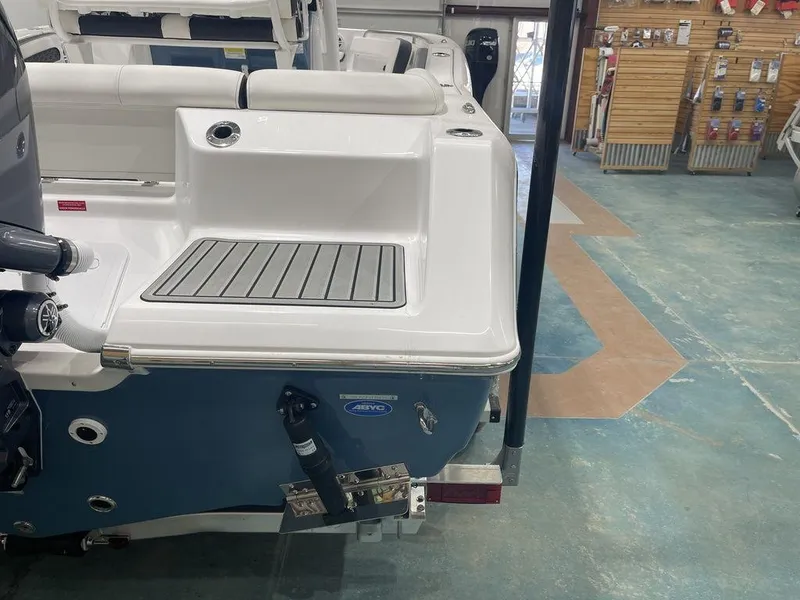 Slide: The Image of 2025 Tidewater 210 LXF boat rear view in showroom, featuring sleek design and modern features. - 34