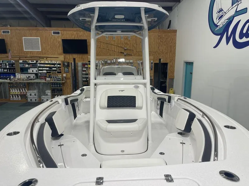 Slide: The Image of 2025 Tidewater 210 LXF boat interior with seating and console in showroom. - 4