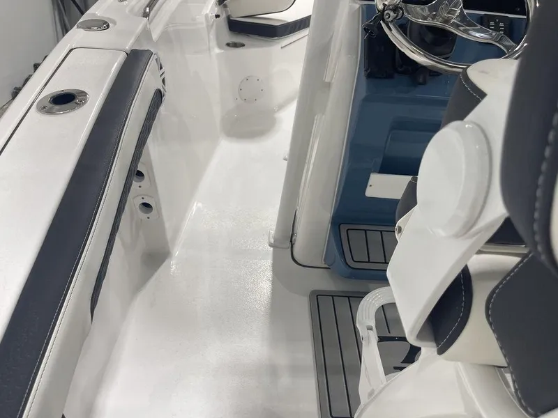 Slide: The Image of Interior view of 2025 Tidewater 210 LXF boat, featuring sleek seating and modern controls. - 5