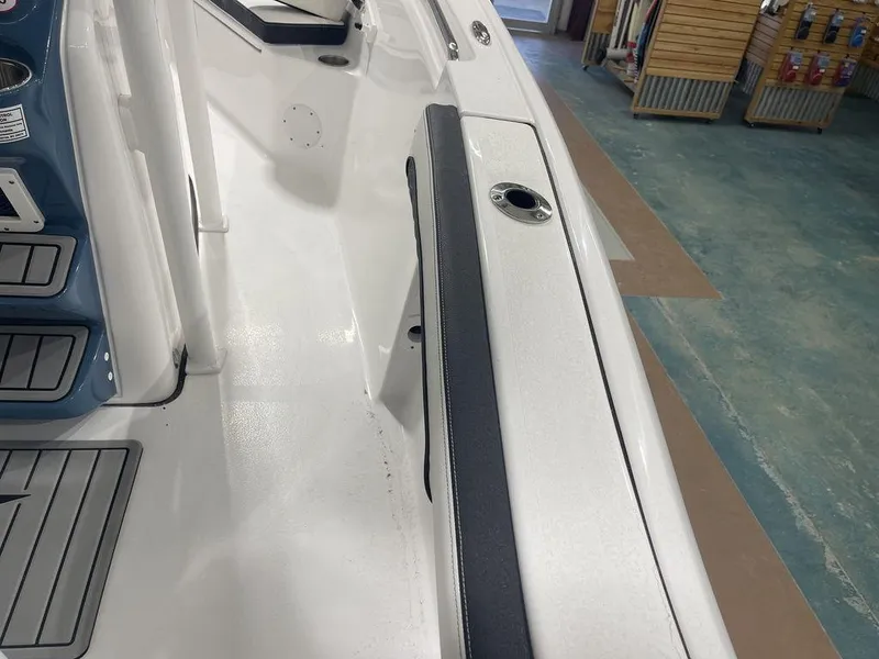 Slide: The Image of 2025 Tidewater 210 LXF boat interior with sleek white and blue design. - 6