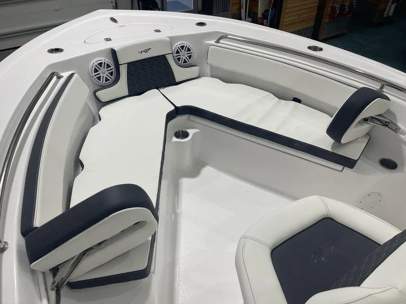 Slide: The Image of 2025 Tidewater 210 LXF boat interior with white and black seating and speakers. - 7