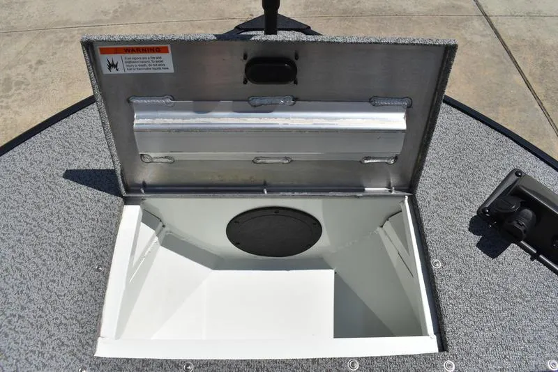 Slide: The Image of Open storage compartment on a 2025 Lowe SD224 boat, featuring a spacious interior. - 11