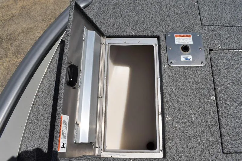 Slide: The Image of Open storage compartment on 2025 Lowe SD224 boat deck. - 16