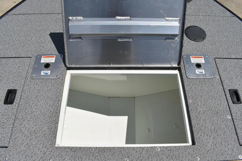 Slide: The Image of Open storage compartment on a 2025 Lowe SD224 boat deck. - 17