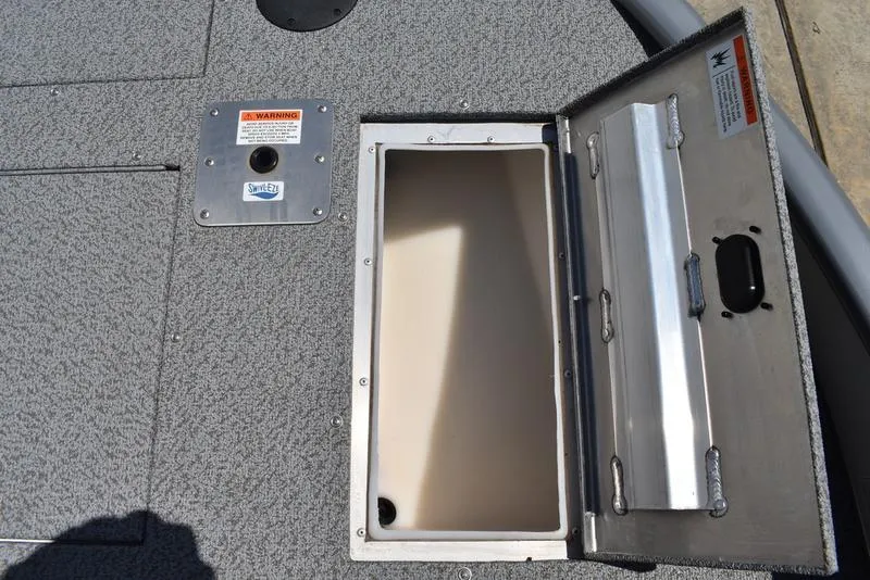 Slide: The Image of Open storage compartment on a 2025 Lowe SD224 boat deck. - 18