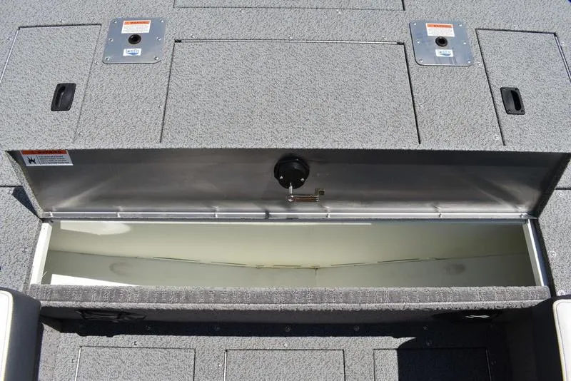 Slide: The Image of Open storage compartment on a 2025 Lowe SD224 boat, featuring a spacious interior. - 19