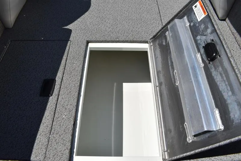 Slide: The Image of Open storage compartment on a 2025 Lowe SD224 boat deck. - 23