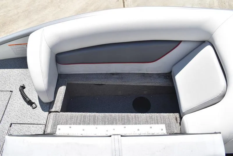 Slide: The Image of Lowe SD224 2025 boat interior with open storage compartment and cushioned seating. - 26