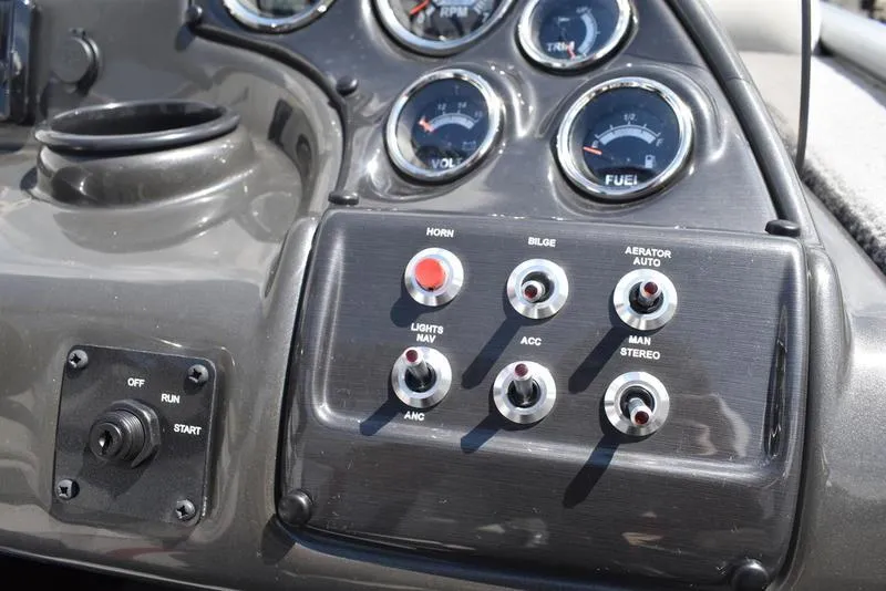 Slide: The Image of Control panel of a 2025 Lowe SD224 boat with switches and gauges. - 33