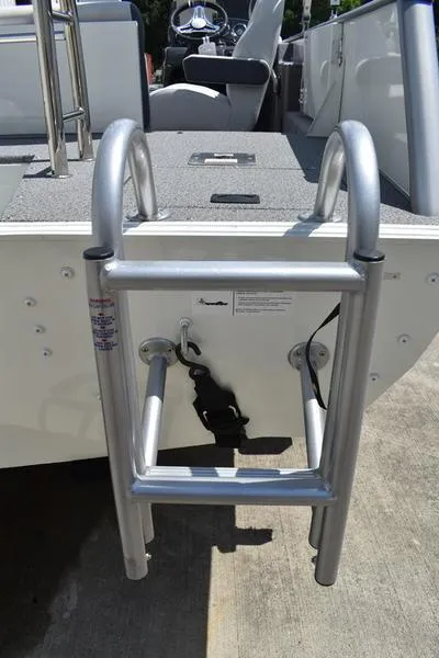 Slide: The Image of Aluminum ladder on Lowe SD224 boat, 2025 model, docked on concrete surface. - 5