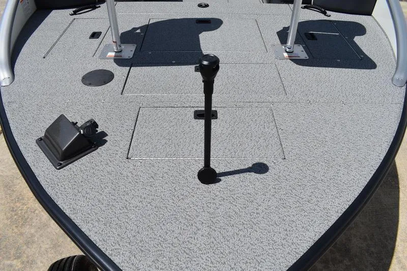 Slide: The Image of 2025 Lowe SD224 boat deck with carpeted surface and storage compartments. - 9