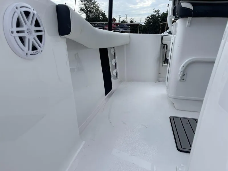 Slide: The Image of 2025 Tidewater 232cc boat interior with white deck and speaker. - 14