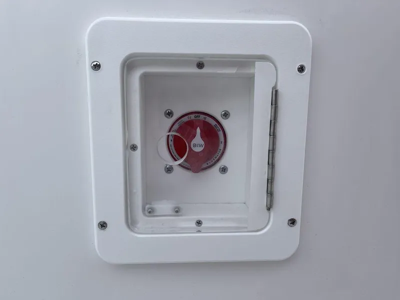 Slide: The Image of 2025 Tidewater 232cc boat battery switch in a white compartment. - 15