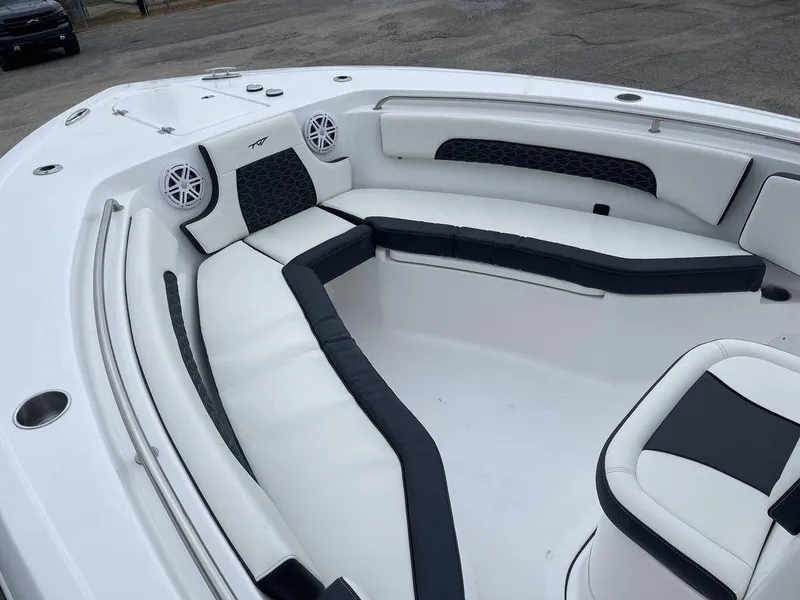 Slide: The Image of 2025 Tidewater 232cc boat interior with white and black seating. - 18