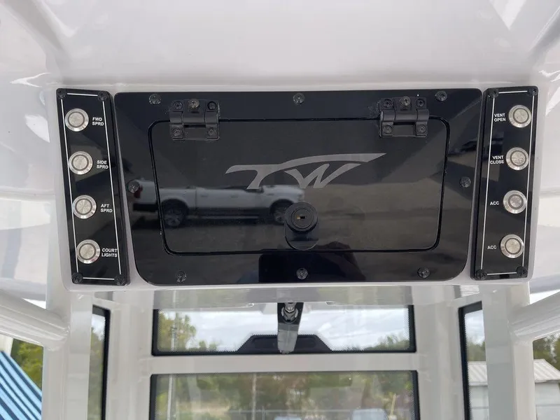 Slide: The Image of 2025 Tidewater 232cc boat console with control panel and storage compartment. - 28