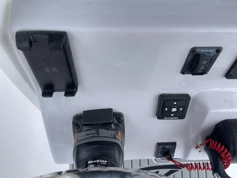 Slide: The Image of 2025 Tidewater 232cc boat dashboard with controls and steering wheel. - 31
