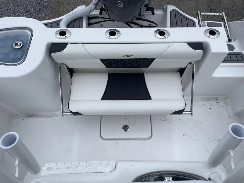 Slide: The Image of 2025 Tidewater 232cc boat interior with white and black seating and rod holders. - 33