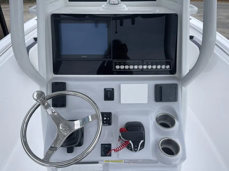 Slide: The Image of 2025 Tidewater 232cc boat console with steering wheel and electronic controls. - 36