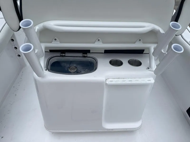Slide: The Image of 2025 Tidewater 232cc boat console with rod holders and storage compartments. - 39