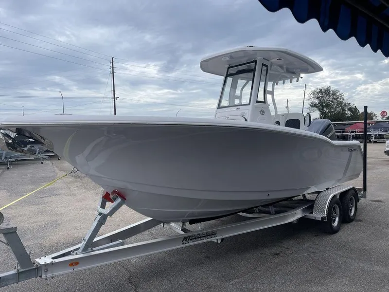Slide: The Image of 2025 Tidewater 232cc boat on trailer, parked outdoors under cloudy sky. - 47