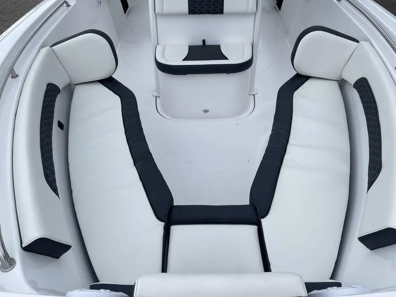 Slide: The Image of 2025 Tidewater 232cc boat interior with white and black cushioned seating. - 6