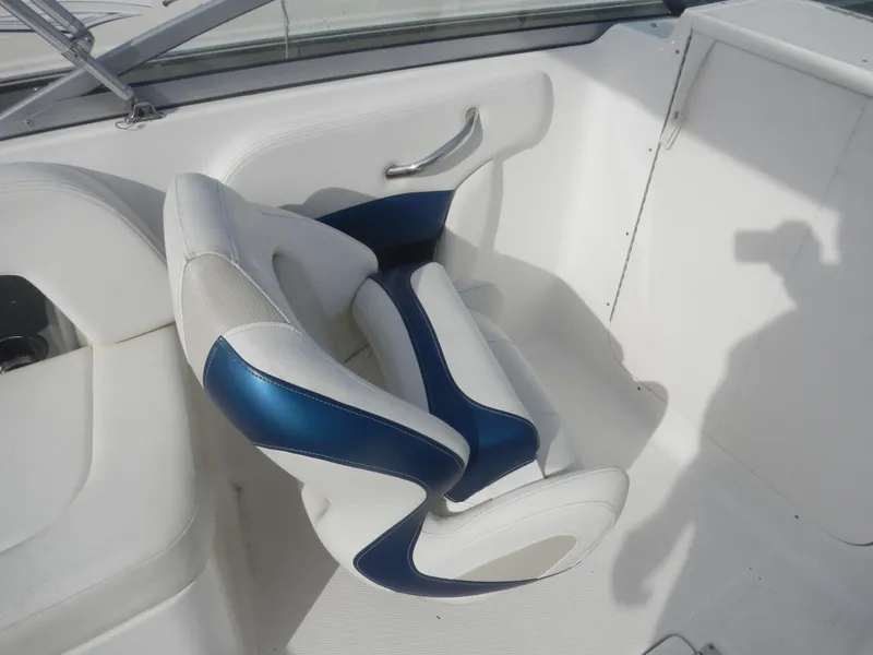 Slide: The Image of 2013 Chaparral 225 SSi boat interior with white and blue seating. - 10