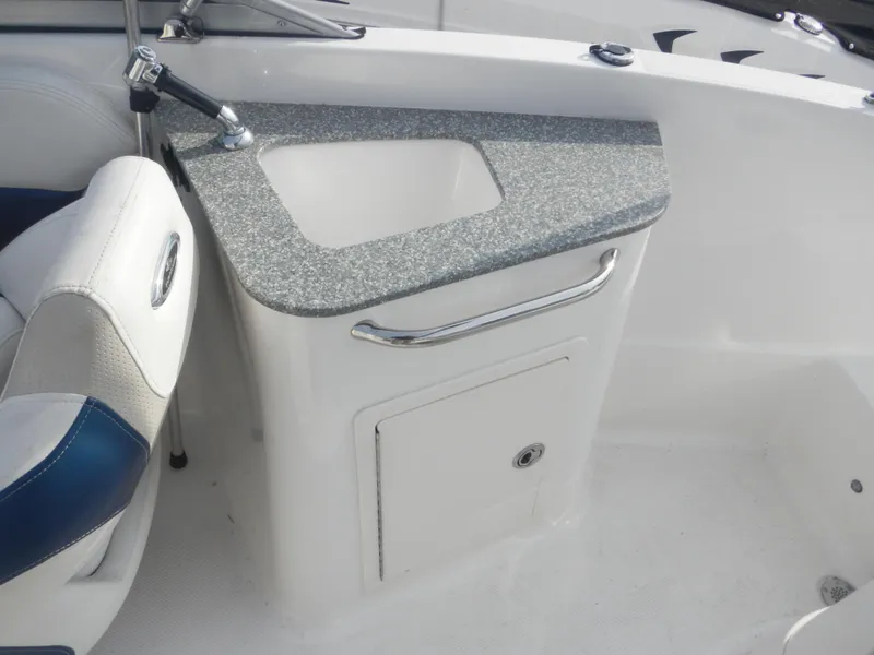 Slide: The Image of 2013 Chaparral 225 SSi boat interior with sink and storage cabinet. - 11