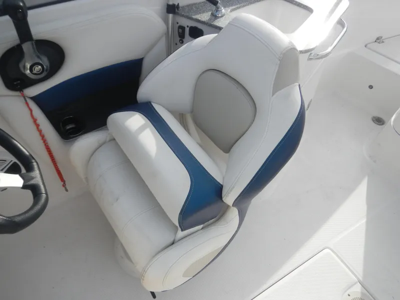 Slide: The Image of 2013 Chaparral 225 SSi boat seat with white and blue upholstery. - 12