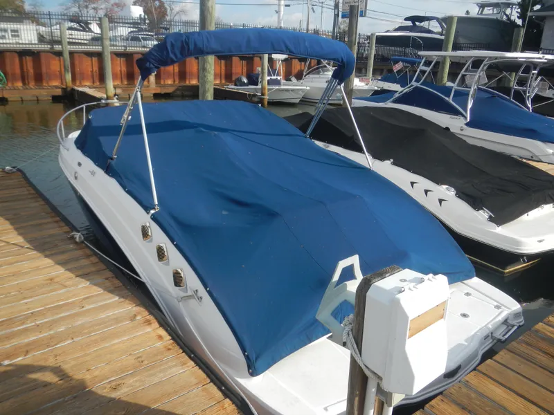 Slide: The Image of 2013 Chaparral 225 SSi boat with blue cover docked at marina. - 4