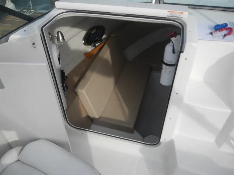 Slide: The Image of 2013 Chaparral 225 SSi boat cabin interior with seating and safety equipment. - 5
