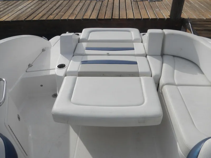 Slide: The Image of 2013 Chaparral 225 SSi boat interior with white cushioned seating. - 6