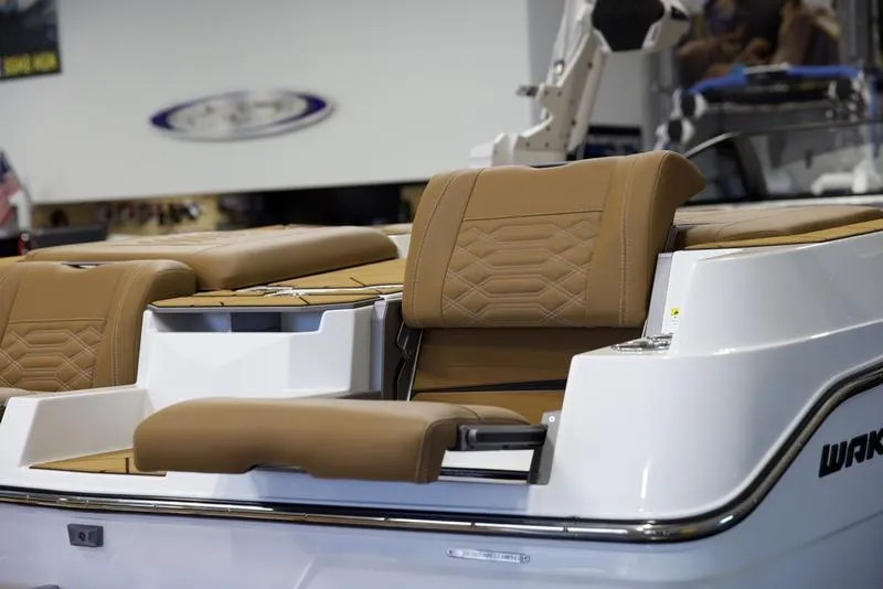 Slide: The Image of 2025 Malibu 26 LSV boat with luxurious tan seating and sleek design. - 11
