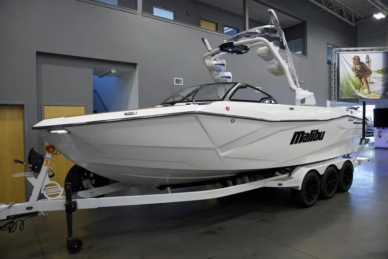 Slide: The Image of 2025 Malibu 26 LSV boat on trailer in showroom. - 12
