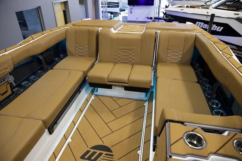 Slide: The Image of 2025 Malibu 26 LSV boat interior with tan seating and modern design. - 13