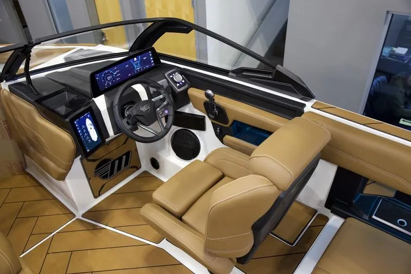 Slide: The Image of 2025 Malibu 26 LSV boat interior with modern dashboard and tan leather seating. - 14