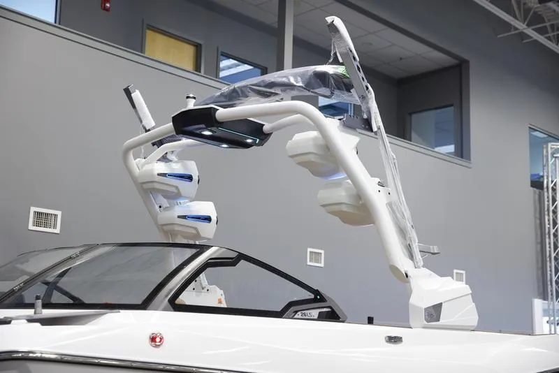 Slide: The Image of 2025 Malibu 26 LSV boat with advanced wakeboard tower in showroom. - 15