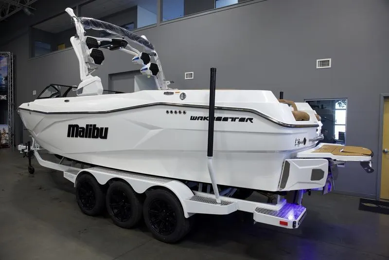 Slide: The Image of 2025 Malibu 26 LSV boat on trailer in showroom. - 17