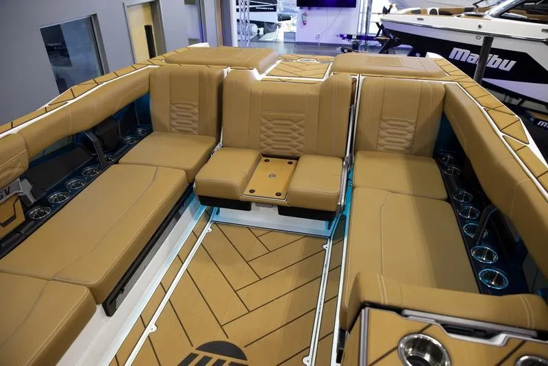 Slide: The Image of 2025 Malibu 26 LSV boat interior with tan leather seating and modern design. - 18