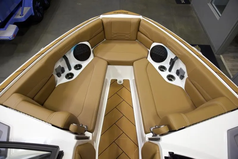 Slide: The Image of 2025 Malibu 26 LSV boat interior with tan leather seating and built-in speakers. - 19