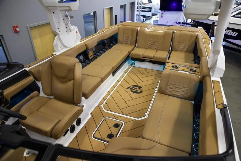Slide: The Image of Luxurious interior of 2025 Malibu 26 LSV boat with tan seating and modern design. - 21