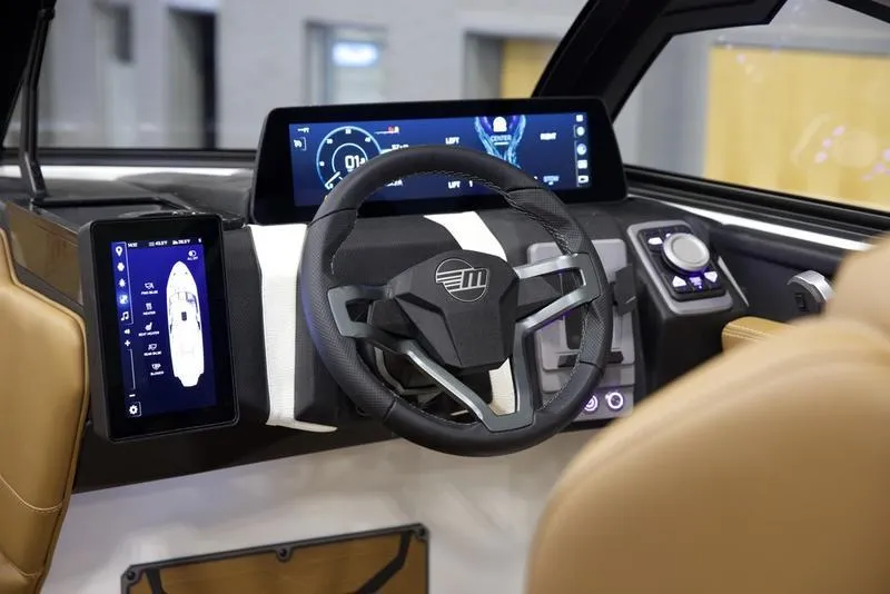 Slide: The Image of 2025 Malibu 26 LSV boat dashboard with modern steering and digital displays. - 23