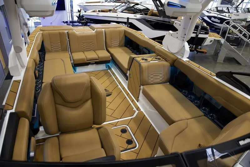 Slide: The Image of Luxurious interior of 2025 Malibu 26 LSV boat with tan leather seating. - 24