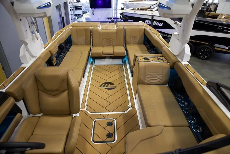 Slide: The Image of Luxurious interior of 2025 Malibu 26 LSV boat with tan seating and sleek design. - 25